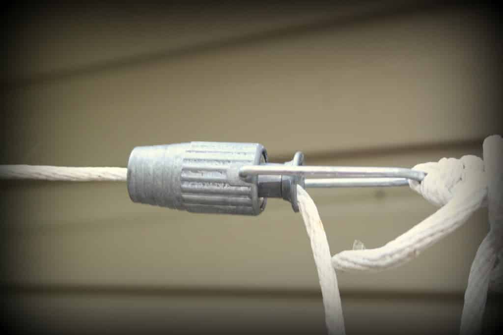 A clothesline tensioner helps to keep the clothesline tight even after the cotton line stretches.