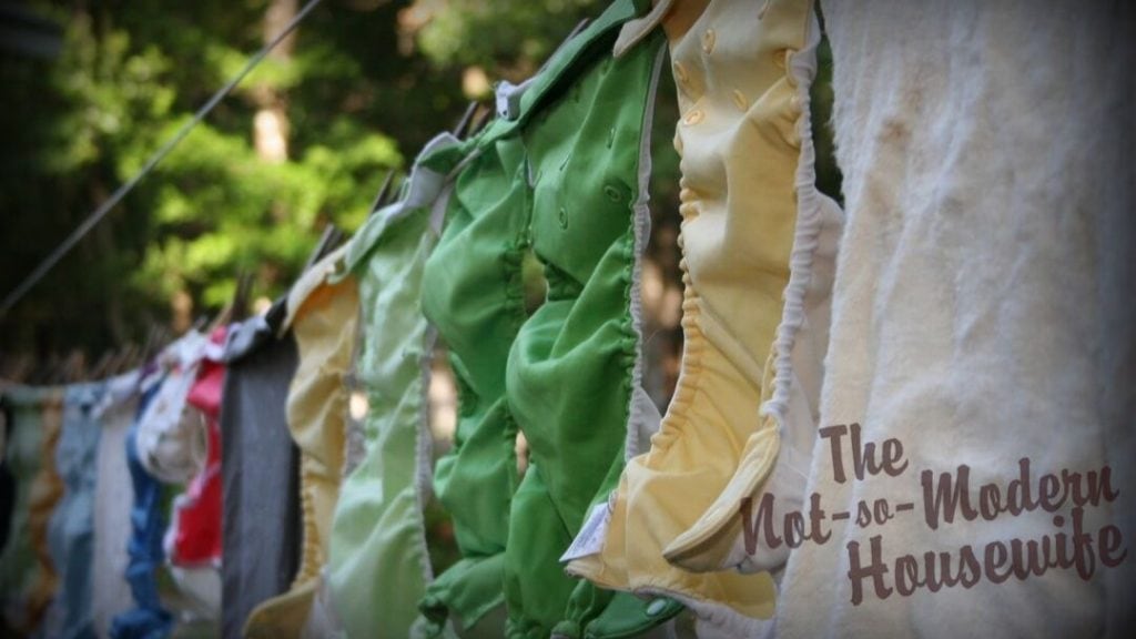 Laundry is hung on the clothesline with clothespins. The fabric can be overlapped to fit more laundry on the line.