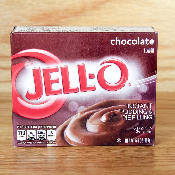 Jello instant chocolate pudding mix box on wood table with wood background