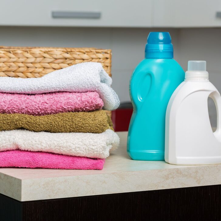 a stack of towels and laundry detergents on a counter - homemade laundry powder without borax