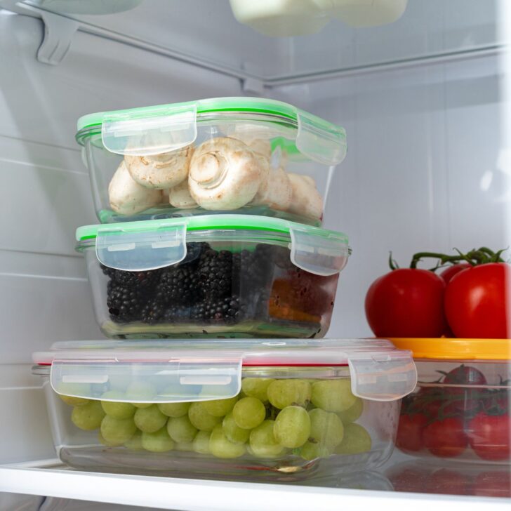 glass containers for food storage with grapes, blackberries, and mushrooms - red tomatoes are in the background - reduce plastic use to help with estrogen dominance