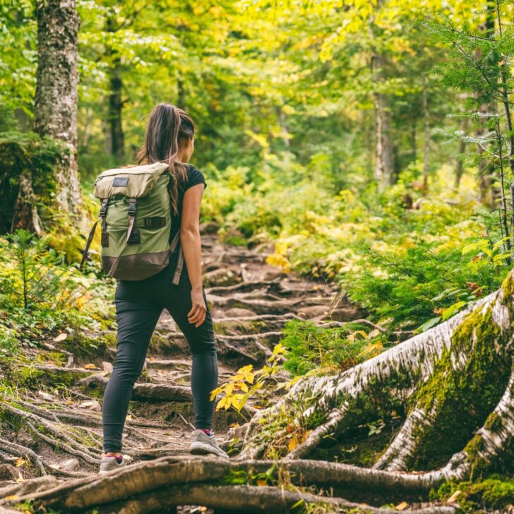 woman hiking with backpack - exercise to balance hormones
